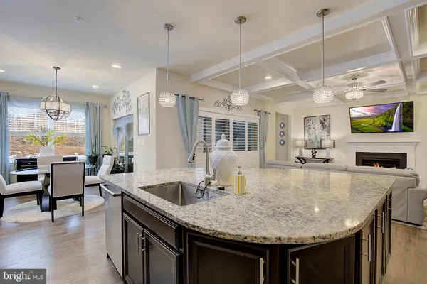 a kitchen with center island table and chairs