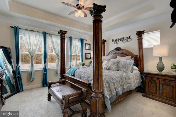 a bedroom with a large bed and a flat tv screen