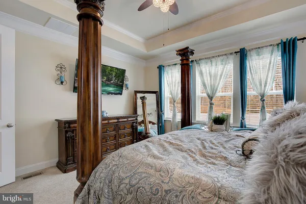 a bedroom with a bed and ceiling fan