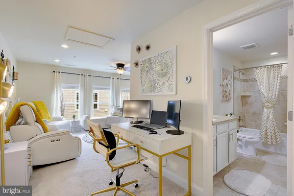 a bathroom with a granite countertop sink a toilet and a shower