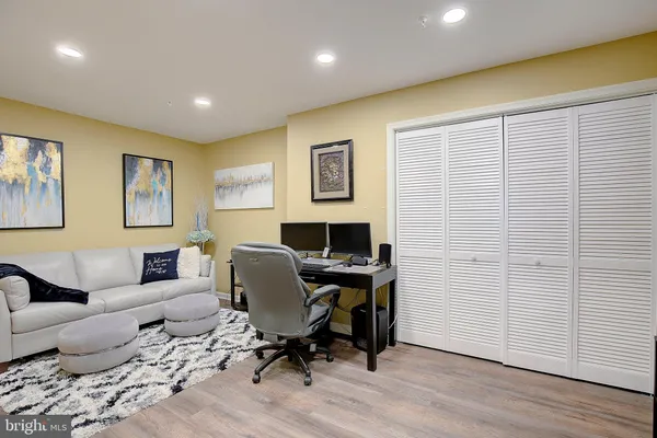 a view of a workspace with furniture and a flat screen tv