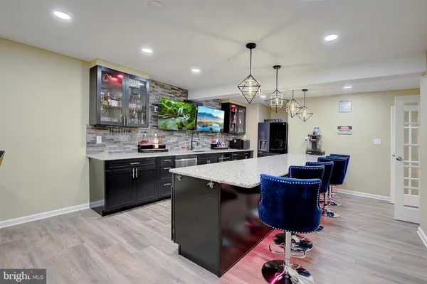 a kitchen with stainless steel appliances granite countertop a sink counter space and wooden floor