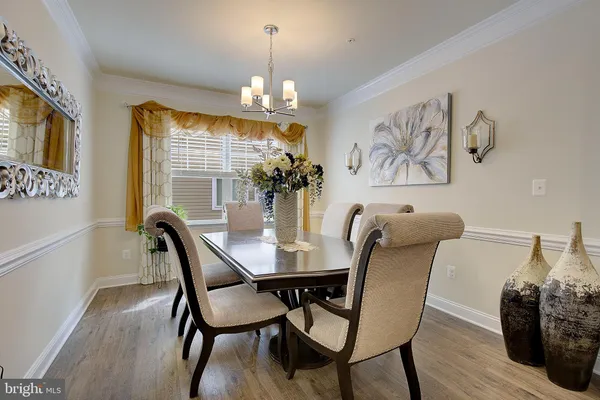a view of a dining room with furniture and chandelier