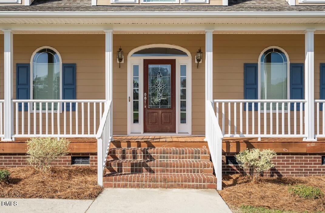 5780 McArthur Road Broadway, NC 27505 - Photo 5 of 40 a front view of a house with a porch