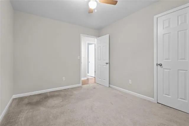 a view of an empty room with a fan