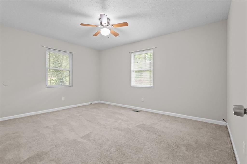 8990 Tweeddale Drive Winston, GA 30187 - Photo 15 of 26 an empty room with windows and fan