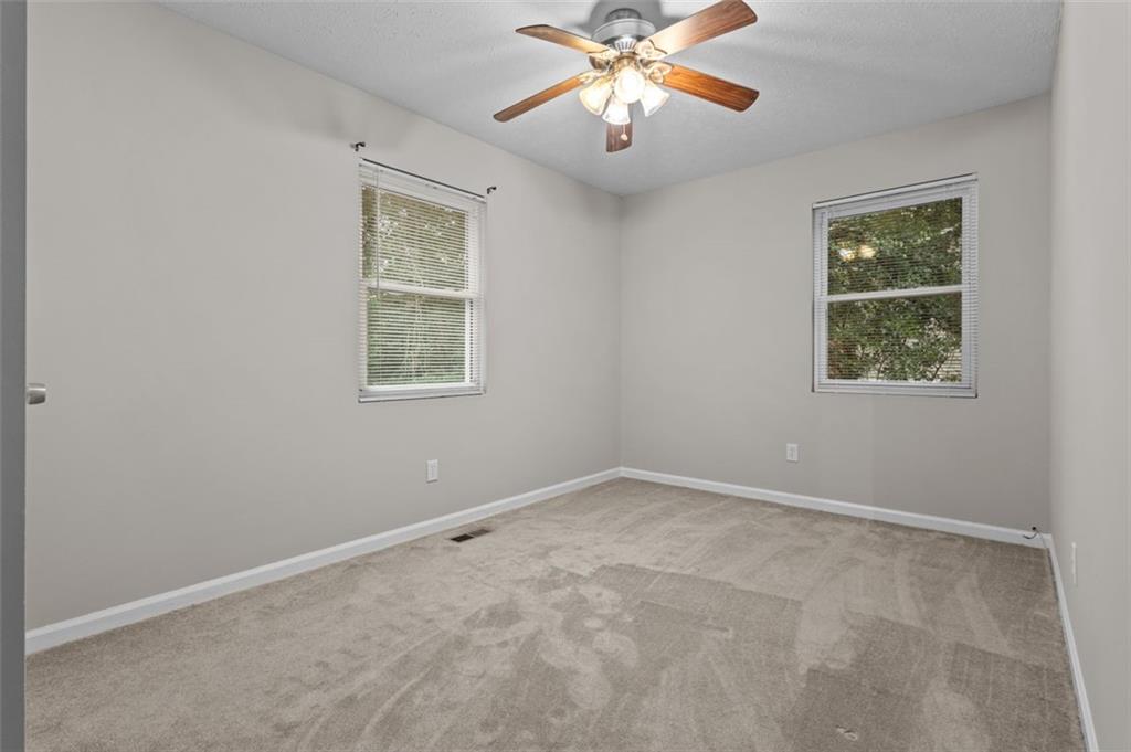 8990 Tweeddale Drive Winston, GA 30187 - Photo 19 of 26 an empty room with windows and fan