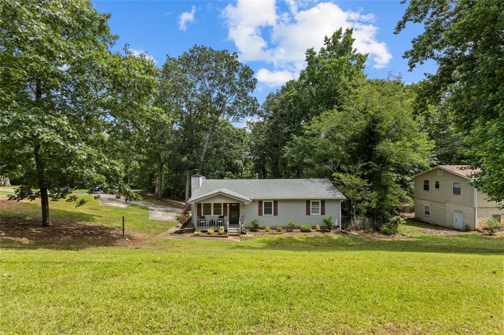 8990 Tweeddale Drive Winston, GA 30187 - Photo 2 of 26 a front view of house with yard and green space