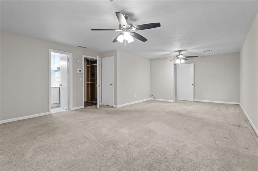 8990 Tweeddale Drive Winston, GA 30187 - Photo 24 of 26 a view of an empty room with a ceiling fan