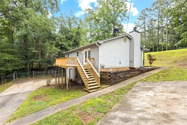 a view of a chair and table in backyard of the house