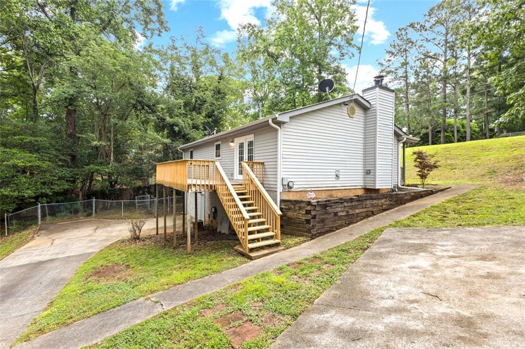 8990 Tweeddale Drive Winston, GA 30187 - Photo 3 of 26 a view of a chair and table in backyard of the house