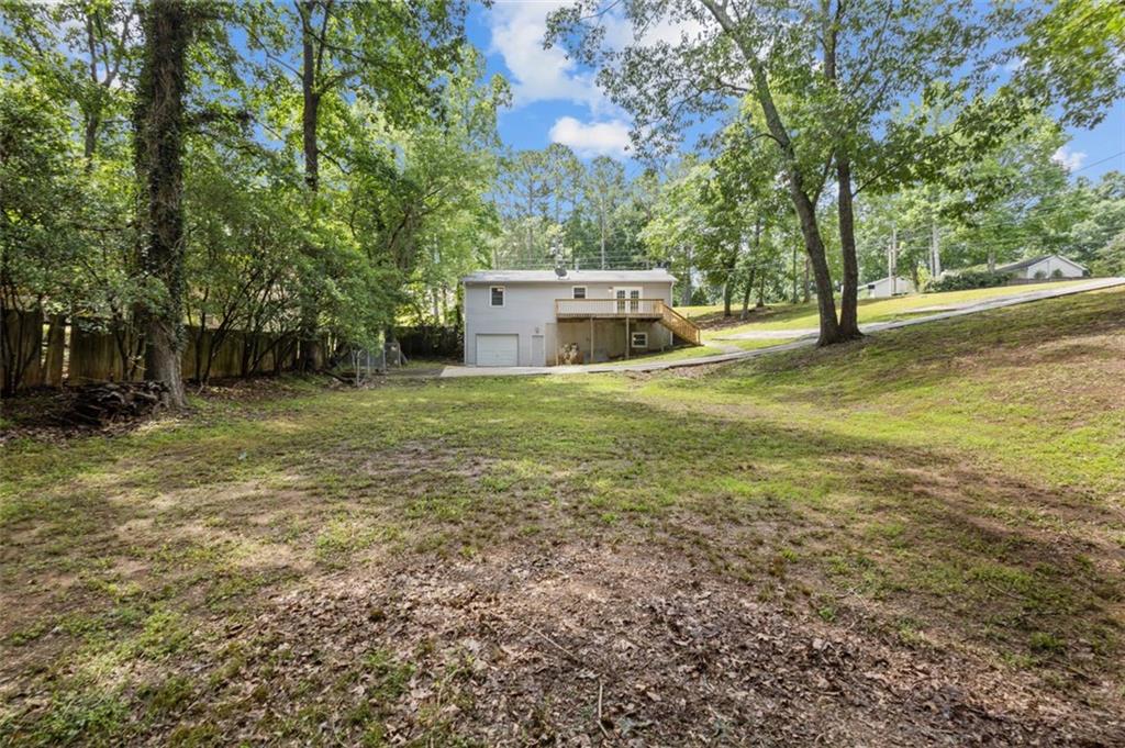 8990 Tweeddale Drive Winston, GA 30187 - Photo 5 of 26 a view of a big yard with large trees