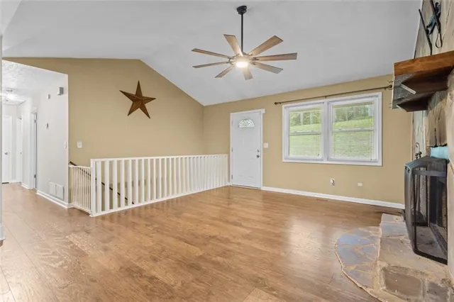 a view of empty room with wooden floor and ceiling window