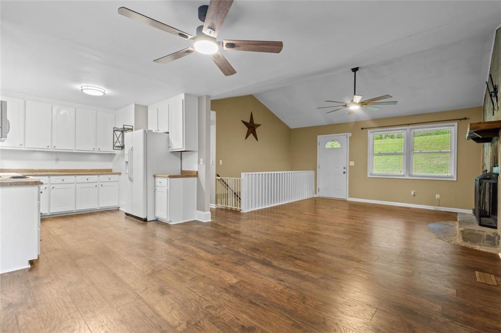 8990 Tweeddale Drive Winston, GA 30187 - Photo 10 of 26 a view of empty room with wooden floor and ceiling window