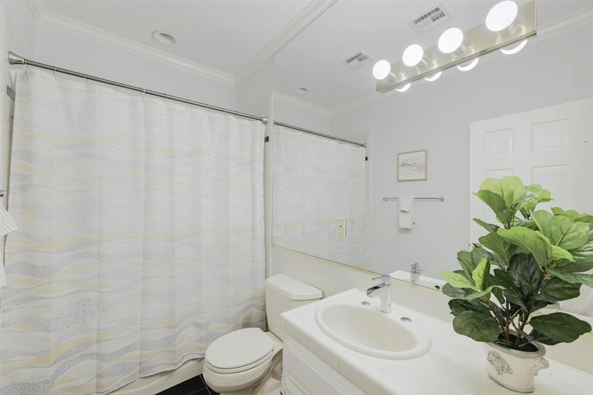 1937 Rue De St Tropez, Unit 9 Austin, TX 78746 - Photo 15 of 33 a bathroom with a sink a toilet and a shower