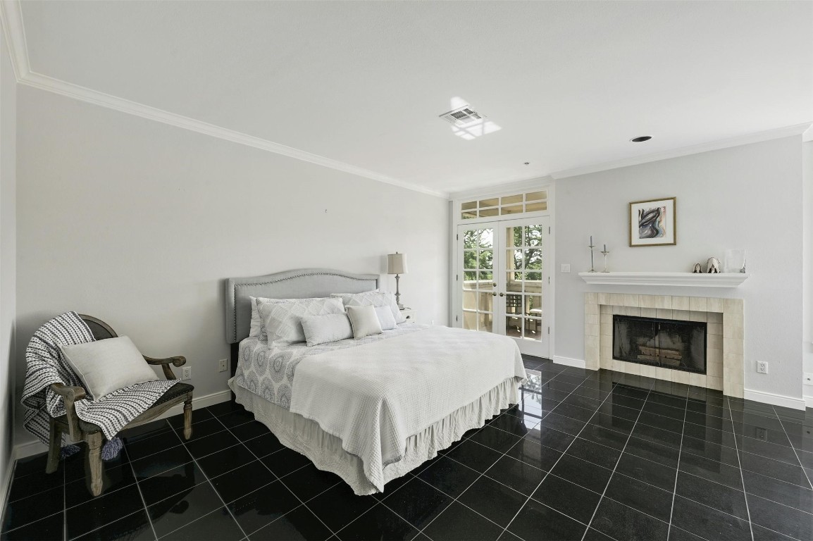 1937 Rue De St Tropez, Unit 9 Austin, TX 78746 - Photo 18 of 33 a bedroom with a bed and a fireplace