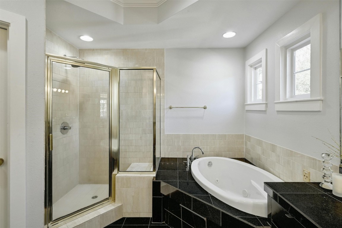 1937 Rue De St Tropez, Unit 9 Austin, TX 78746 - Photo 21 of 33 a bathroom with a bathtub shower sink and toilet