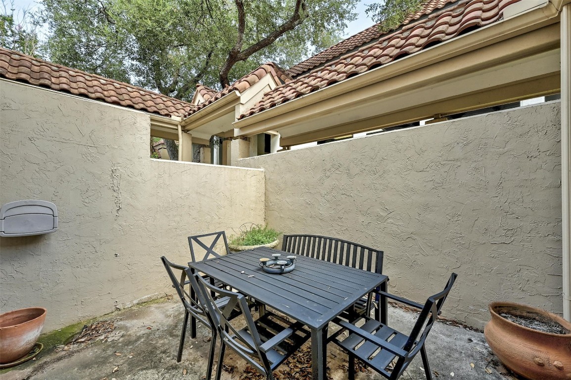 1937 Rue De St Tropez, Unit 9 Austin, TX 78746 - Photo 27 of 33 a view of a patio with table and chairs