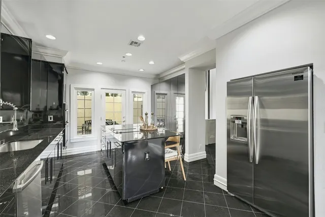a kitchen with stainless steel appliances granite countertop a refrigerator and a sink