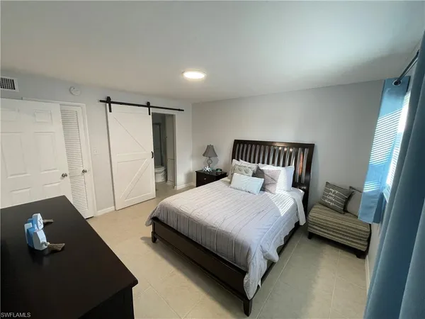 a bedroom with a bed and a couch