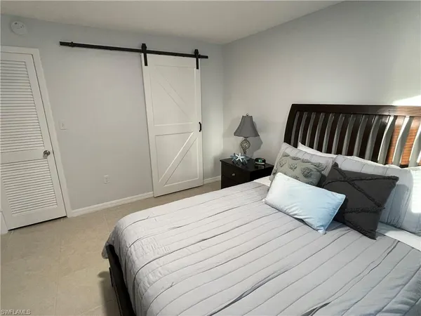a bedroom with a bed and a couch