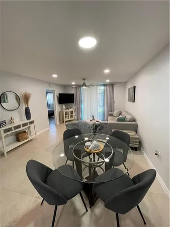 a living room with furniture a table and chairs