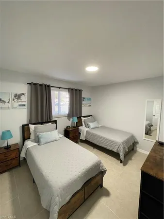 a living room with a bed and flat screen tv