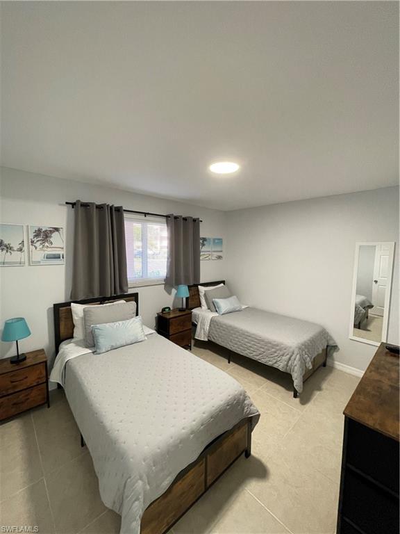 170 Turtle Lake Court, Unit 103 Naples, FL 34105 - Photo 22 of 37 a bedroom with bed and window