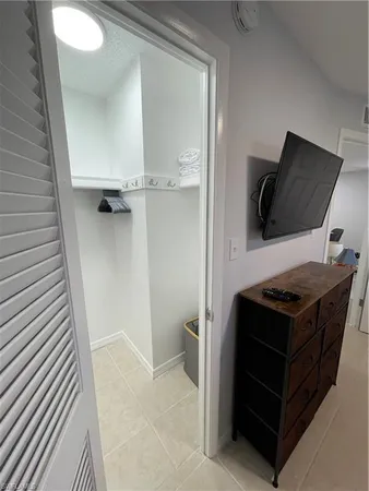 a bathroom with a toilet sink vanity and shower