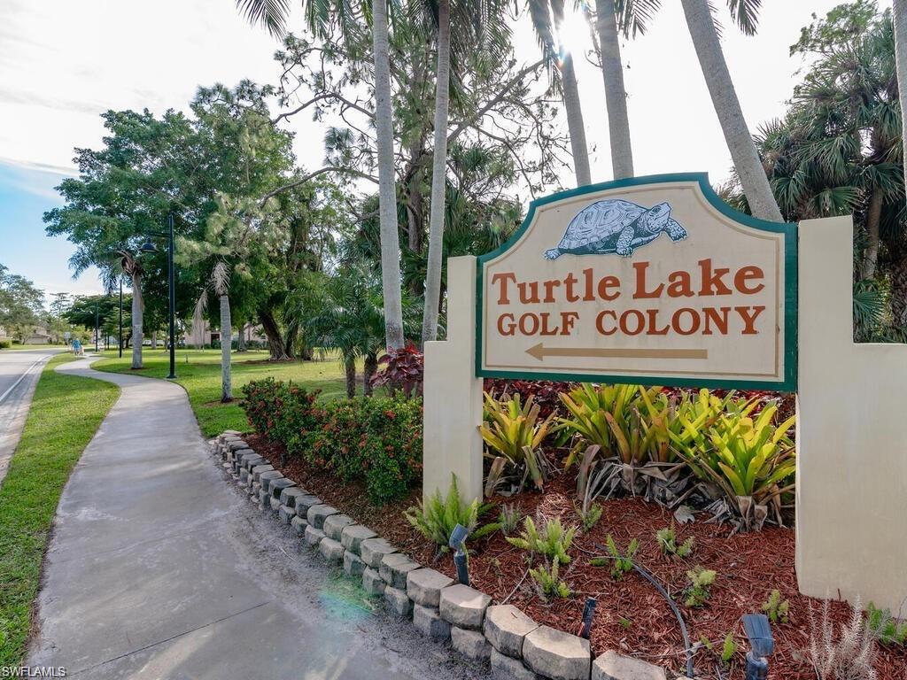 170 Turtle Lake Court, Unit 103 Naples, FL 34105 - Photo 29 of 37 a view of a street sign under a large tree