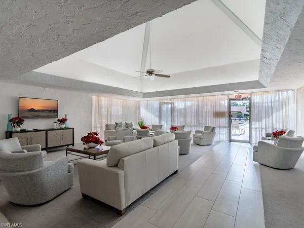 a living room with pool table and a large window