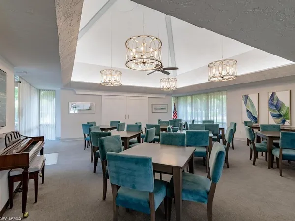 a view of a dining room with furniture and a bookshelf