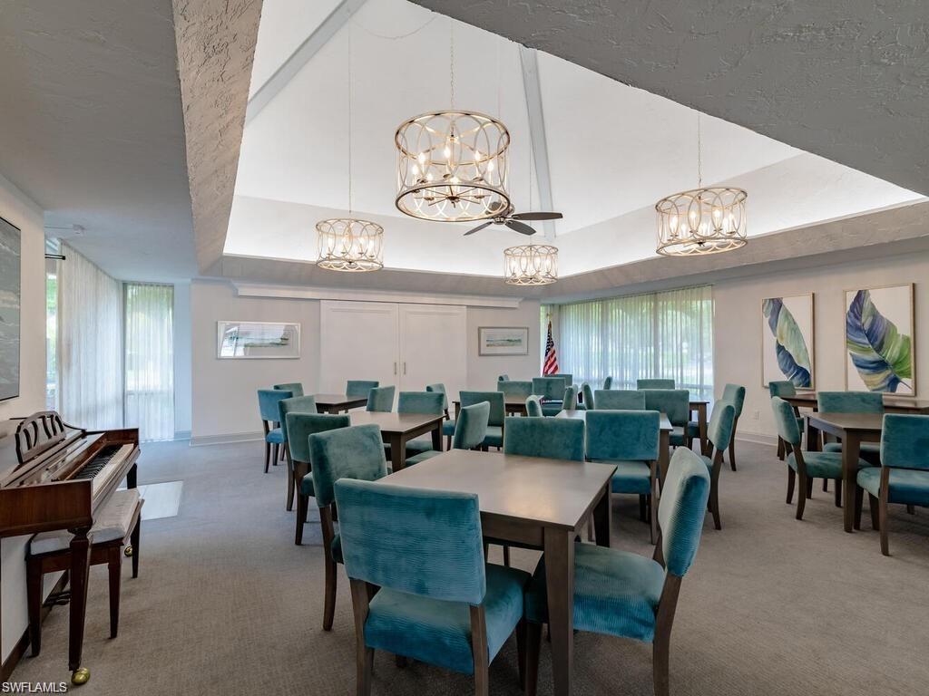 170 Turtle Lake Court, Unit 103 Naples, FL 34105 - Photo 32 of 37 a view of a dining room with furniture and chandelier