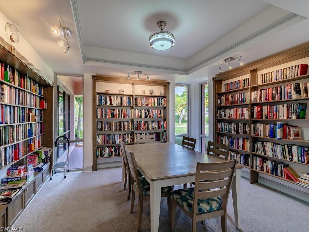 170 Turtle Lake Court, Unit 103 Naples, FL 34105 - Photo 34 of 37 a view of a dining room with furniture and a bookshelf