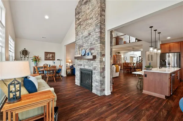 a living room with furniture a fireplace and wooden floor
