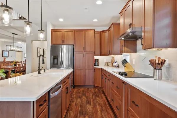 a kitchen with stainless steel appliances a sink stove and refrigerator