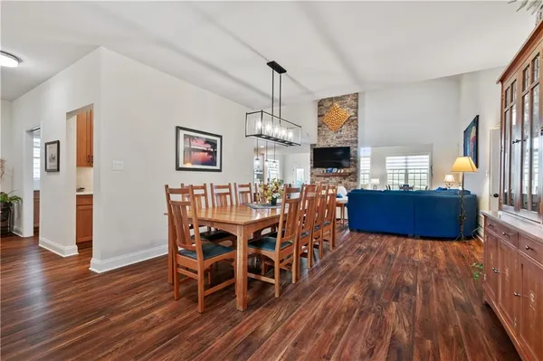 a view of a dining room with furniture wooden floor and chandelier