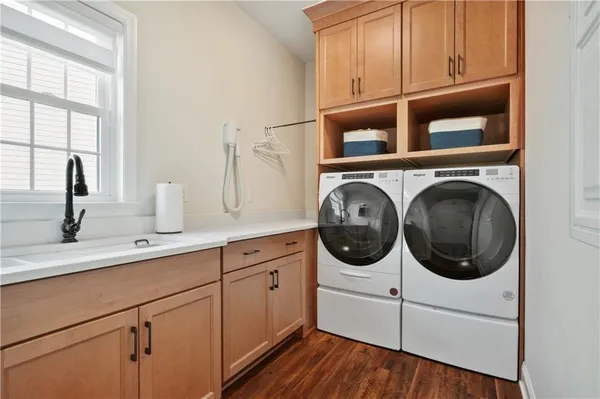 a utility room with sink dryer and washer
