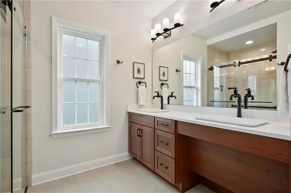 a spacious bathroom with a double vanity sink mirror and double
