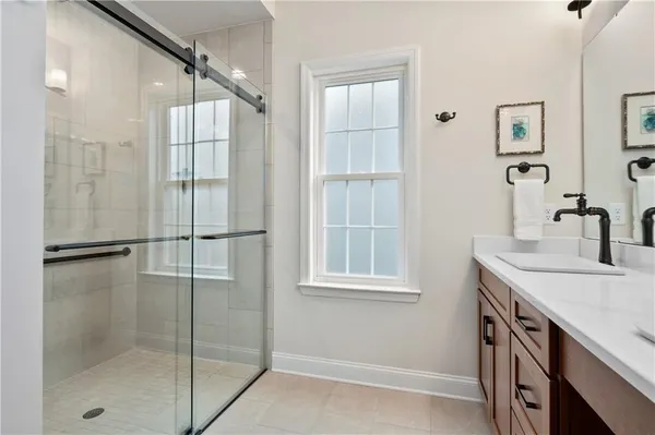 a bathroom with a shower sink and mirror