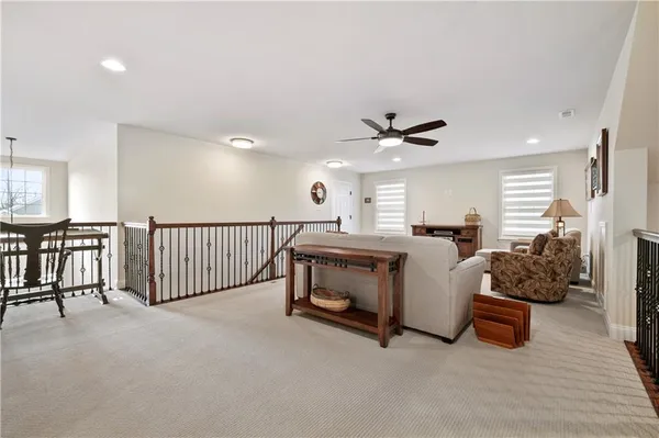 a bed room with furniture and a ceiling fan