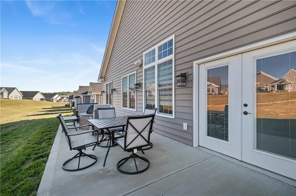 a view of a patio with table and chairs and potted plants
