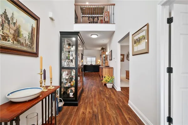 a view of a hallway with wooden floor and furniture