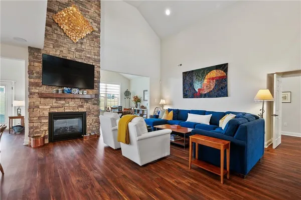 a living room with furniture a flat screen tv and a fireplace