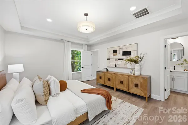 a bedroom with a large bed and a window