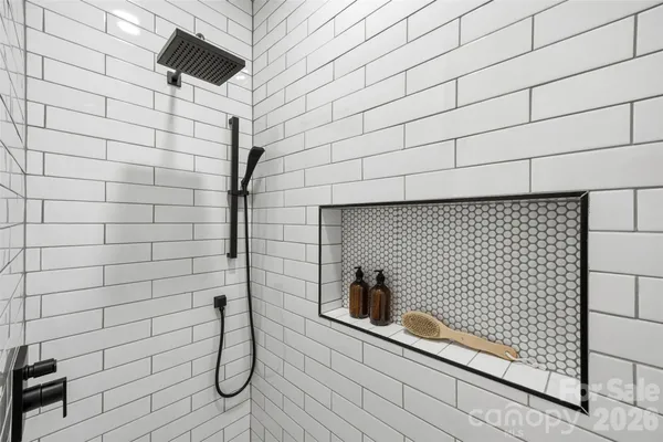 a white toilet sitting next to a white wall
