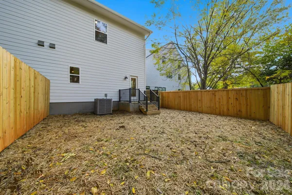 a backyard of a house with wooden fence