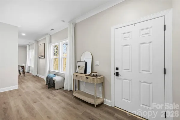 a hallway with a sink and a mirror