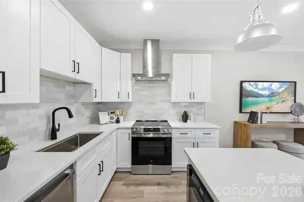 a kitchen with stainless steel appliances a stove sink and cabinets