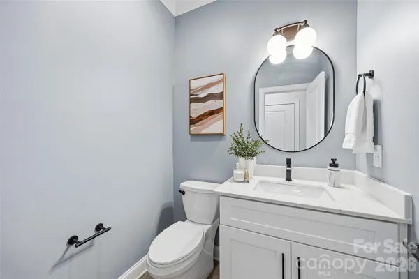 a bathroom with a toilet a sink and mirror